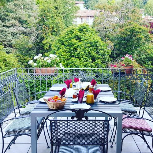 a table with a bowl of fruit on a patio at B&B Villa Tavallini in Pollone