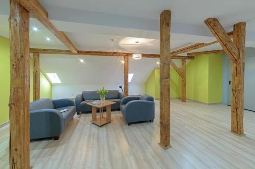 a waiting room with blue couches and a table at Sanatorium Uzdrowiskowe Chemik in Duszniki Zdrój