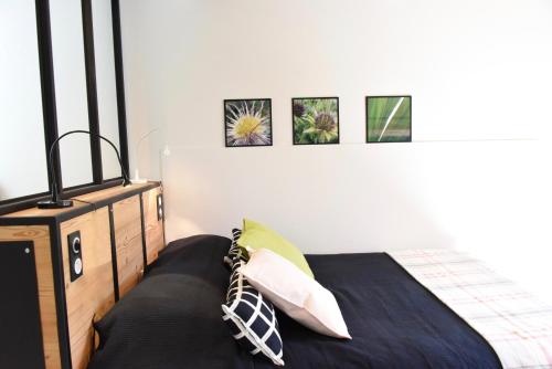 a bedroom with a bed and a dresser at Barcelo Appart'hotel in Barcelonnette