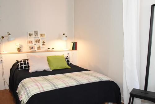 a bedroom with a bed with a green pillow on it at Barcelo Appart'hotel in Barcelonnette