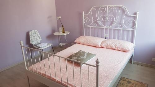 a bedroom with a bed with a white bed frame at Iride in Bergamo