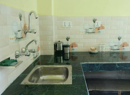 a kitchen with a sink in the middle of it at Everest Home Stay Apartment in Pātan