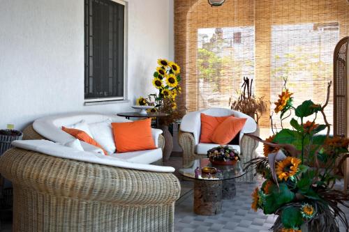 a living room with two chairs and a table at B&B Villa Ines in Leuca
