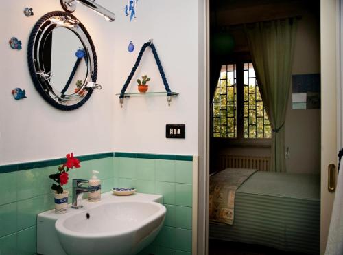 a bathroom with a sink and a bed and a mirror at B&B Villa Ines in Leuca