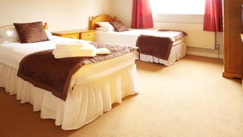 A bed or beds in a room at Park Lodge 
