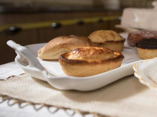 a plate with three muffins on a table at B&B Villa Ines in Leuca