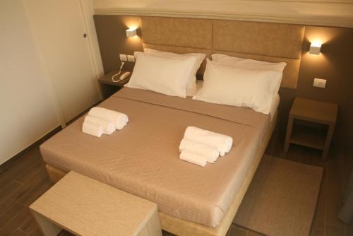 a bedroom with a bed with two towels on it at International Hotel Dakar in Dakar