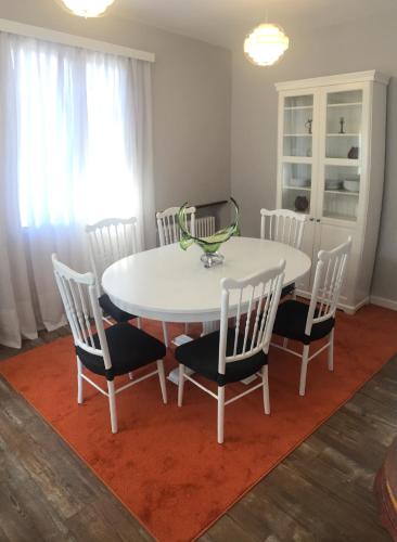 a dining room table and chairs with a white table and a table and chairsktop at Getxo, parking, wifi, metro in Getxo