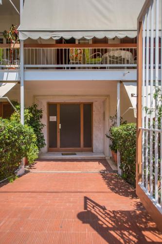 a brick walkway leading to a building with a balcony at Starapartment Athens-Varkiza Top 2 in Varkiza