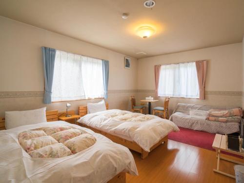 Guesthouse Hoshizora no Akari tesisinde bir odada yatak veya yataklar