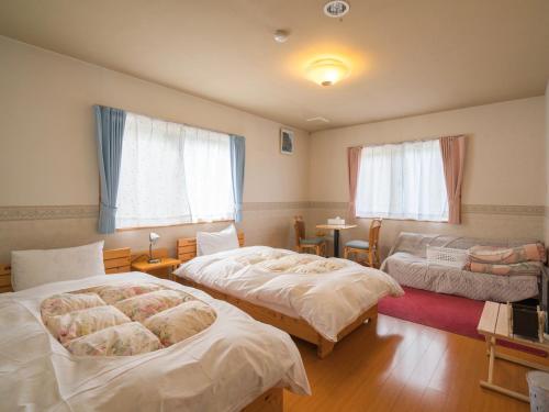 Postel nebo postele na pokoji v ubytování Guesthouse Hoshizora no Akari