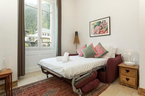 a bed in a room with a large window at Apartment Majestic 1 in Chamonix-Mont-Blanc