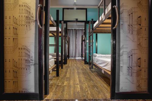 a room with two bunk beds and a hallway at The Guest Hotel Krabi in Krabi town