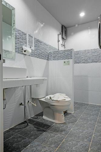 a bathroom with a toilet and a sink at The Guest Hotel Krabi in Krabi town
