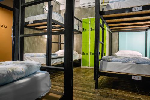 a room with three bunk beds in it at The Guest Hotel Krabi in Krabi town