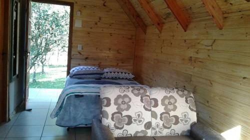 A bed or beds in a room at Pousada Rio do Ouro