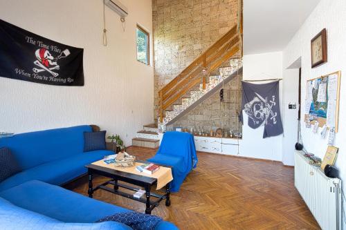 a living room filled with furniture and a blue couch at Hostel Pirate in Ulcinj
