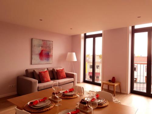 a living room with a couch and a table at Innapartments São Gonçalinho II in Aveiro