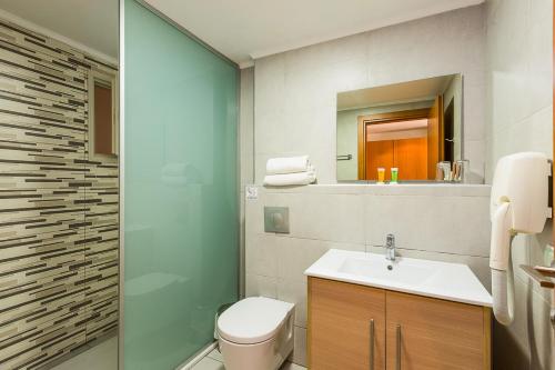 a bathroom with a toilet and a sink and a mirror at Xidas Garden in Bali