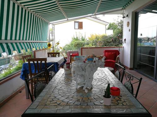 a table and chairs on a patio at The Incantation Guest House in Montesilvano