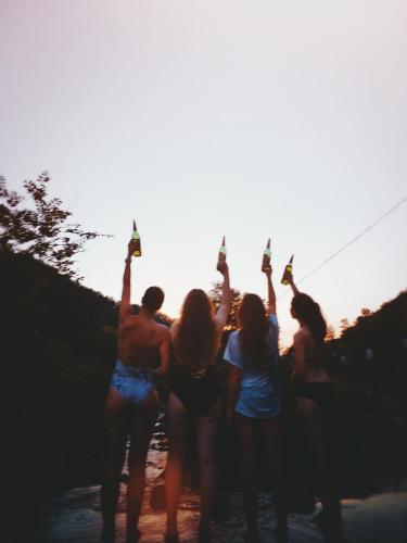 a group of people holding up their beer bottles at Tongfu Inn(In the National Park) in Zhangjiajie