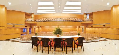 a conference room with a table and chairs at Ramyas Hotel in Tiruchchirāppalli