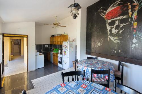 a kitchen filled with furniture and a table at Hostel Pirate in Ulcinj