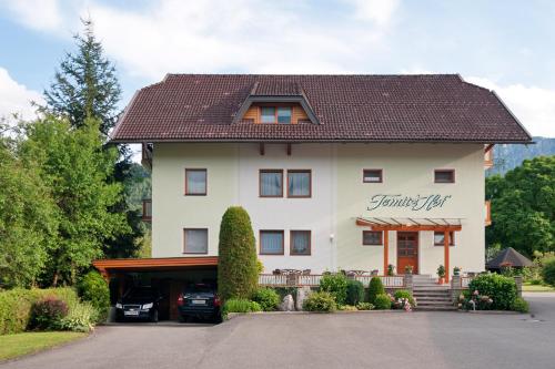a large white house with a gambrel roof at Gästehaus Temitzhof in Latschach