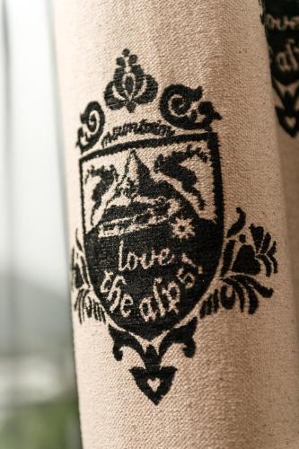 a black tattoo of a crown on a persons leg at Alpenlove - Adult SPA Hotel in Seefeld in Tirol