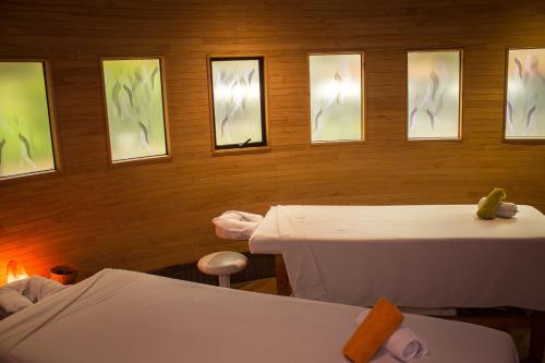 a room with two tables and pictures on the wall at Hotel Bosque de Reñaca in Viña del Mar