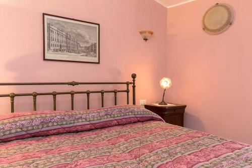 a bedroom with a bed and a picture on the wall at Villa Mereghetti in Corbetta