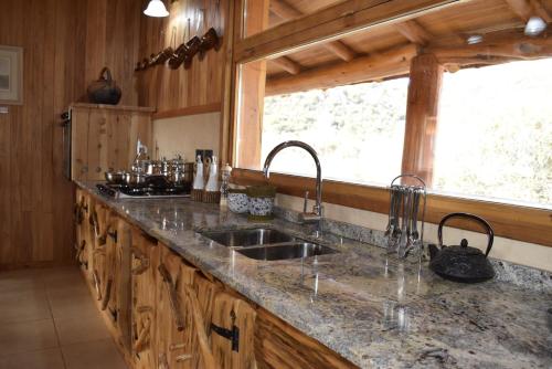 a kitchen with a sink and a window at Casa del Lago in Lago Meliquina