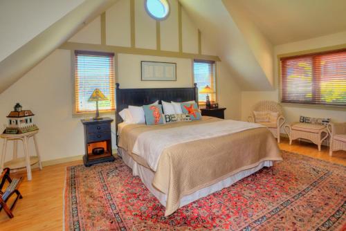 a bedroom with a large bed and a rug at The Eagle Harbor Inn in Winslow