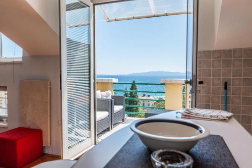 a bathroom with a tub and a view of the ocean at Piano Nobile & Penthouse in Villa Near Beach in Opatija