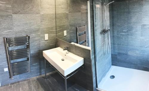 a bathroom with a sink and a shower at Gidea Park Hotel in Romford