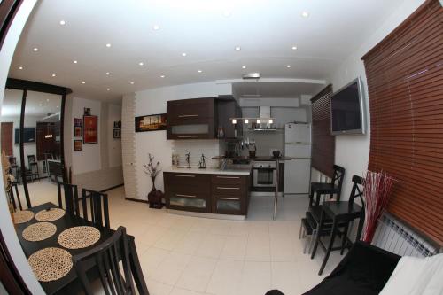 a kitchen and living room with a table and chairs at Аксакова,72 Трехкомнатные апартаменты in Ufa