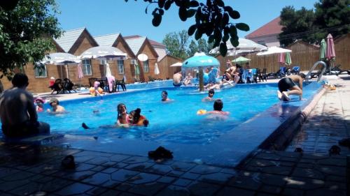 a group of people in a swimming pool at Hotel Bulaq in Turist