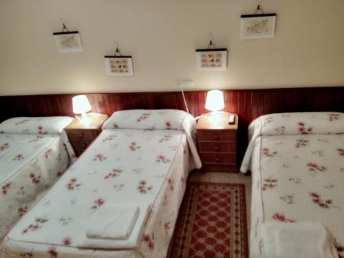 A bed or beds in a room at Hostal Mayo