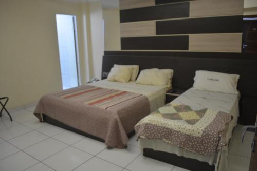 Postel nebo postele na pokoji v ubytování Hotel Calstar