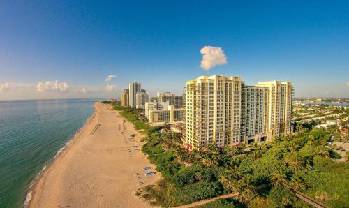 an aerial view of a beach and buildings at Oceanfront Palm Beach Resort & Spa Singer Island in Riviera Beach