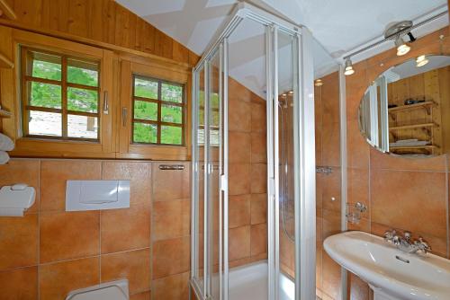 a bathroom with a shower and a sink at Chalet Tuk-Tuk in Zermatt