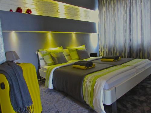 a bedroom with two beds with yellow pillows at Hotel 108 in Hamburg