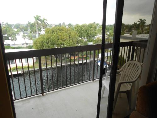 a balcony with a chair and a view of the street at Surfsider Resort - A Timeshare Resort in Pompano Beach