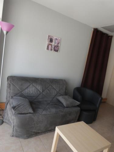 a living room with a couch and a table at Gite Du Comtal in Bozouls