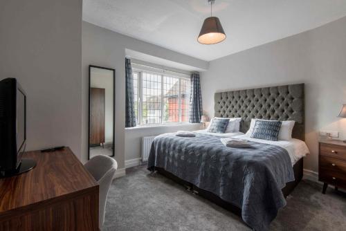 a bedroom with a large bed and a window at M-Hotels Apartments in London