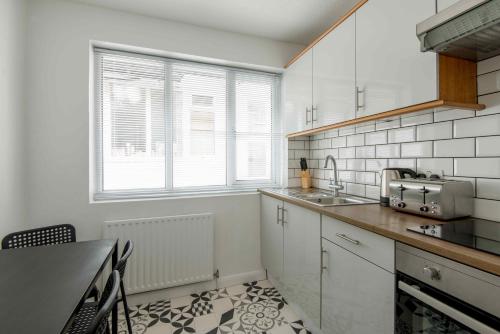 a kitchen with a sink and a counter top at M-Hotels Apartments in London