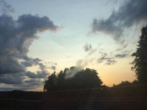 a cloudy sky with trees in front of a highway at Ferienwohnungen Kössl in Waidhofen an der Ybbs