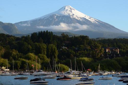 a mountain with a bunch of boats in a harbor at Pucón in Pucón
