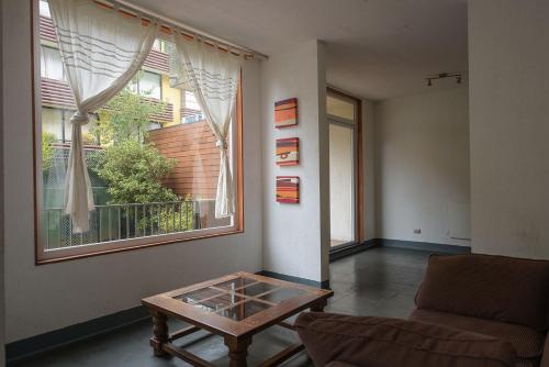 a living room with a couch and a coffee table at Pucón in Pucón