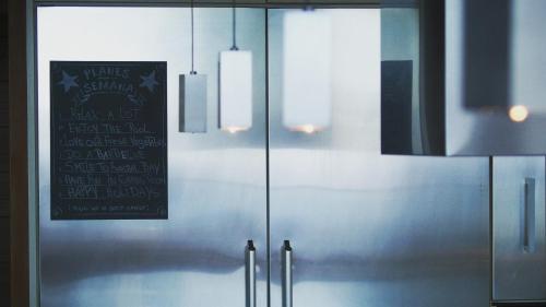 a sliding glass door with lights and a sign on it at Villa Cary in Funchal